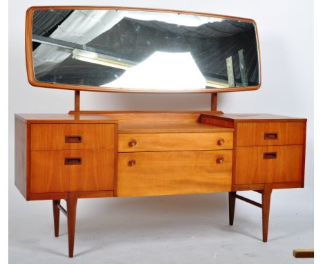 Nathan - A retro vintage mid 20th Century British design dressing table chest of teak construction having a bevelled teak fra