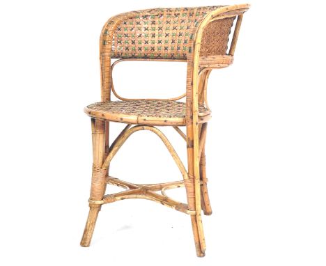 A retro vintage early 20th Century bamboo &amp; cane bedroom chair having a peacock type fan back with intricate woven green 