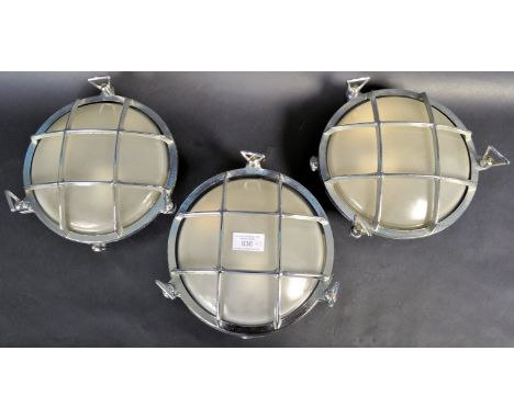 A set of three retro vintage 20th Century ships bulkhead industrial wall lights / lamps of circular roundel form with grill f