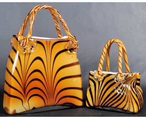Two retro vintage mid 20th Century opaque glass models of handbags with each having twist handles with the bodies of each bag