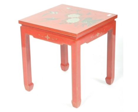 A mid 20th Century Chinese red lacquered side / lamp table of simple square form with floral and bird decoration atop with gi