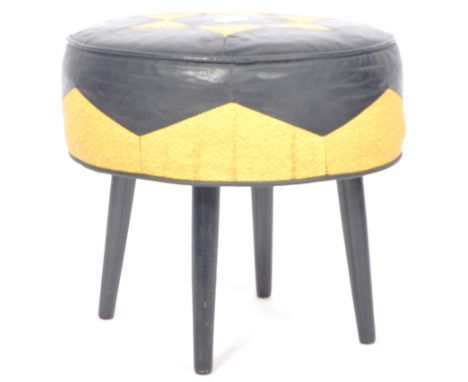 A retro vintage 1960's vinyl dressing table stool / footstool having a black and yellow vinyl upholstery raised on shaped tap