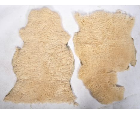 A pair of original vintage retro 1960's sheepskin floor carpet rugs, both constructed from Ivory wool on cloth backing. Measu