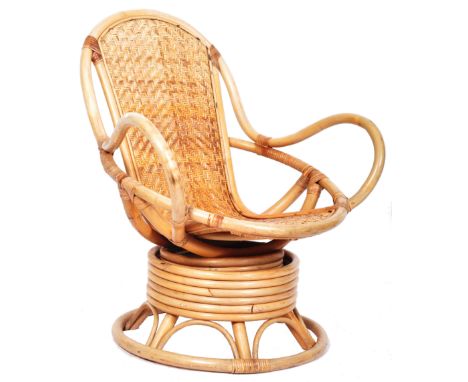 A retro vintage mid 20th Century 1960's bamboo &amp; cane armchair / lounge chair having a shaped bamboo frame and arms with 