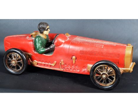 A large 20th Century vintage style model of a 1930's Bugatti type race car having a red painted finish with inset driver and 