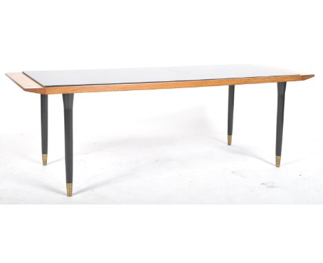 A retro vintage mid 20th Century coffee table of rectangular form having a teak framed top with drop in black glass center wi