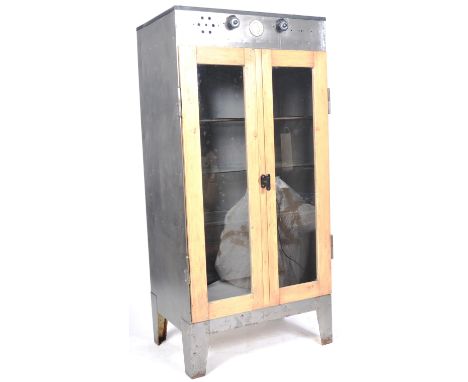 An original 1960's vintage industrial lab cabinet / egg incubator having a polished steel frame body raised on four angular b