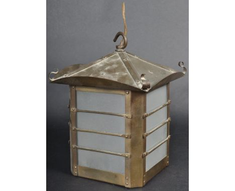 A late 19th / early 20th Century Art Nouveau hanging lantern light of brassed copper constructions having a flared sloping co