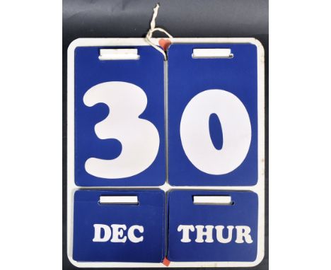 Habitat - A retro vintage 20th Century 1970's perpetual calendar having a white enameled wall mountable backplate with blue a
