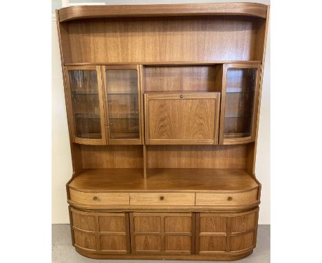 A very large vintage Nathan 2 sectional teak wall unit, #4154 Combination unit.  With rounded sides, concealed lighting, glaz