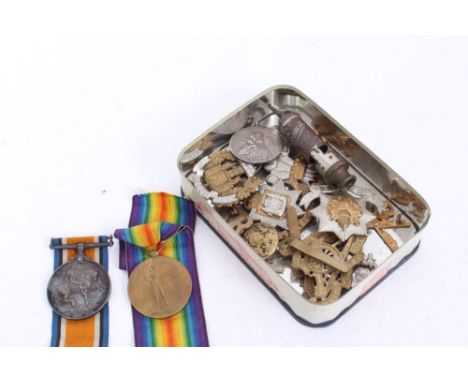 First World War pair comprising War and Victory medals named to 14028. DVR. G. Stanhope. R.A. Together with cap badges
