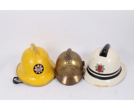 French brass fire helmet, an Essex fire brigade helmet and a London fire brigade helmet (3)