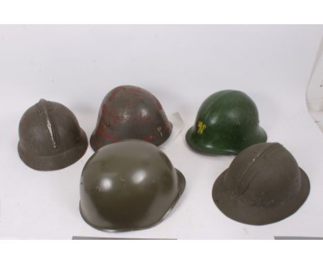 Group of various military helmets to include Czech steel helmet, French M26 Steel helmet with Polish markings, Belgian M26 st