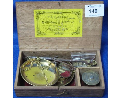 Cased set of Avery hand scales with brass pans and steel beam together with various brass weights.