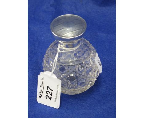 Small hobnail cut glass globular scent bottle with engine turned silver top.