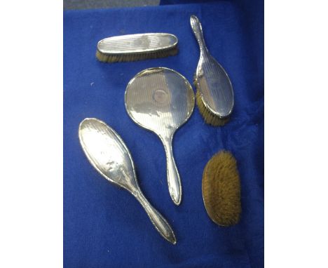 Five piece engine turned silver dressing table brush and mirror set.  Birmingham hallmarks.