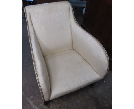 Early 20th Century upholstered armchair on metal casters.