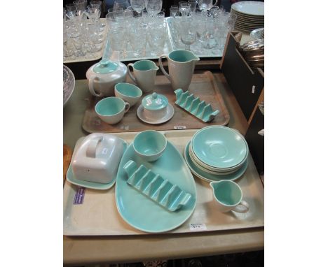 Two trays of Poole pottery tea ware items on a grey and turquoise ground comprising cups, saucers, butter dish and cover, jug