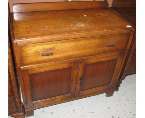 Mid 20th century oak single drawer sideboard with blind panel cupboards on square legs.