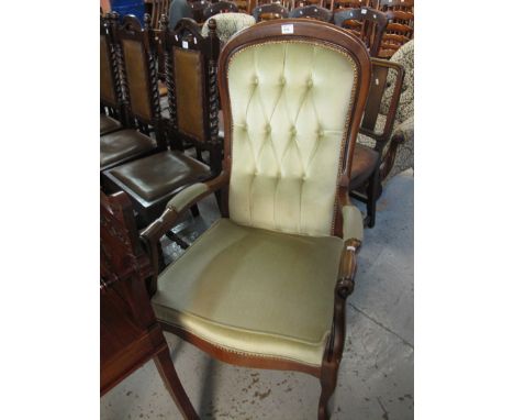Reproduction button back show frame fire side armchair on cabriole legs.