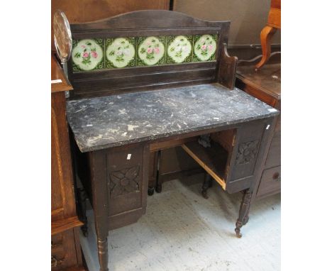 Edwardian stained tile back, marble top washstand on metal casters.