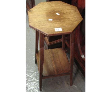 Small oak jardiniere stand with octagonal top and under shelf.