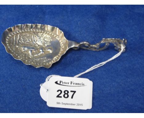 Dutch silver repousse caddy type spoon with figural decoration.