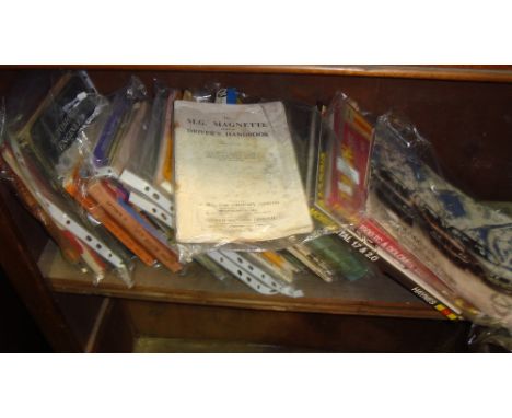 Shelf of motoring books including car manuals (automobilia interest)