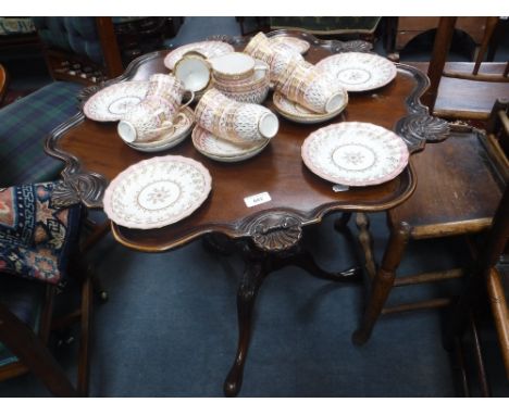 A CHIPPENDALE STYLE MAHOGANY TRIPOD TABLE with pie-crust top and carved foliate and shell decoration