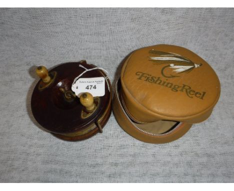 A VINTAGE WOODEN FISHING REEL, with brass fitments in a fitted fishing reel case
