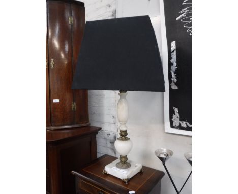 A WHITE ONYX AND GILT TABLE LAMP, with a black shade