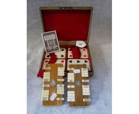 A VINTAGE "BEZIQUE" SET, in a fitted case, with wooden and ivory score boards with a silver (not tested) monogram, circa 1920