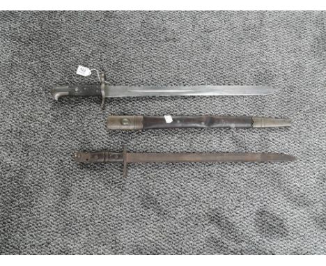 A Martini Henry Sawback Bayonet for use by the Royal Artillery 1875 with leather scabbard, marked 155 on cross guard, helmet 