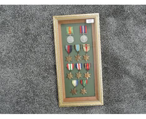 A framed and glazed display of WWII Medals, Defence and War, Stars 1939-45, Atlantic, Air Crew Europe, Africa 8th Army Clasp,