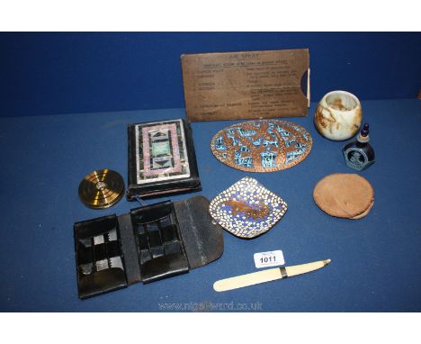A cased stainless steel knife set and bottle opener, two copper and enamel plaques, small scent bottle, letter opener, two co