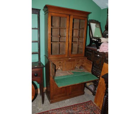 A 19th c. Oak Secretaire Bookcase with glazed two door, two shelf top on secretaire base with fitted drawer having drawers, p