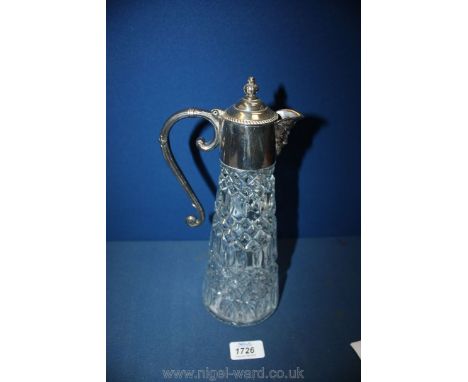 A glass Decanter with white metal top and figure spout