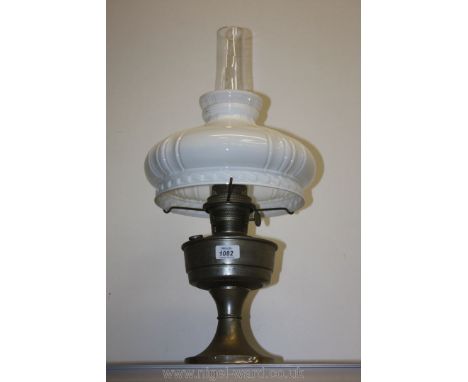 A paraffin Lamp with chimney and white shade