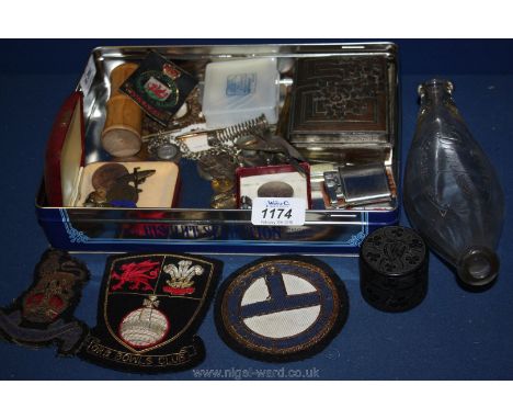 A quantity of miscellanea including wooden dice shaker, Ronson lighter, badges, coins, cuff links, cloth badges etc