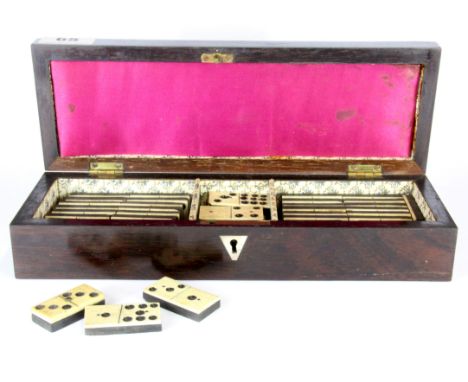 A mother of pearl inlaid and rosewood veneered Edwardian cribbage box containing a set of dominoes, box size. 29 x 9.5 x 6cm.