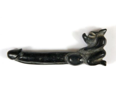 A Chinese phallic form carved dark jade /hardstone amulet, L. 9.5cm. (Prov. Samy collection).