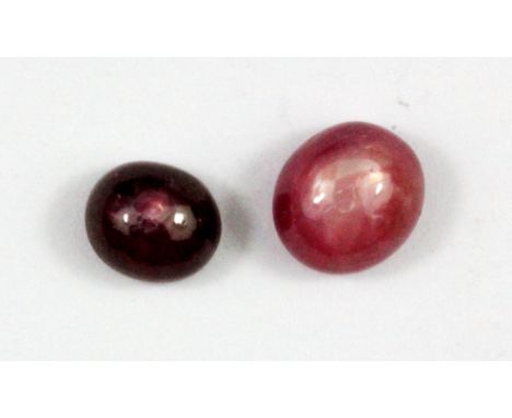 Two unmounted cabochon cut star ruby, approx. 2.5ct, 0.7 x 0.4xm &amp; 1.47ct, 0.7 x 0.3cm.