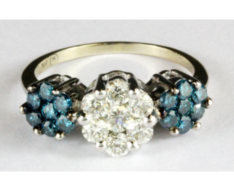 A 14ct white gold (stamped 14k) diamond and fancy intense blue diamond set triple cluster ring, (Q).