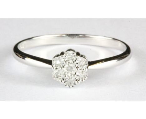 A 9ct white gold diamond set cluster ring, (N.5).