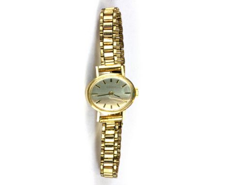A 9ct yellow gold Tissot wrist watch on a rolled gold strap.