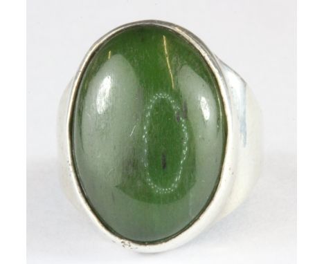 A hallmarked silver and cabochon cut jade set ring, (I).