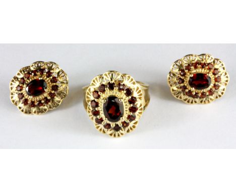 A 14ct yellow gold (stamped 14k) garnet set ring and matching pair of earrings, (one butterfly missing), (O).