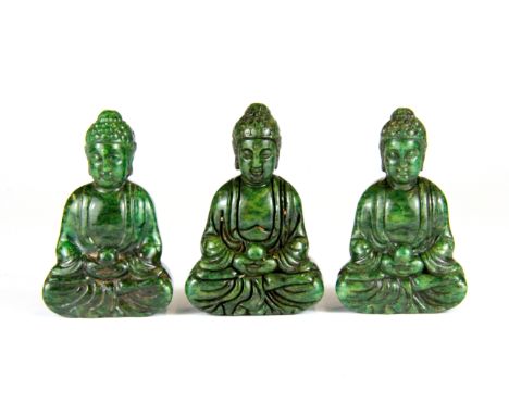 A group of three dark green jade / hardstone figures of the seated Buddha, H. 6cm.