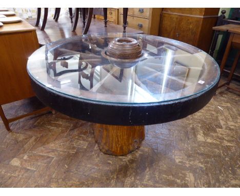 Dining table constructed from substantial iron rimmed cartwheel on tree trunk base, glass topped (46" diameter) 