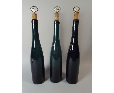A Set of Three Coloured Glass Decanters with Mother of Pearl Mounted Corks for Sherry, Gin and Hock. 36 Cm High